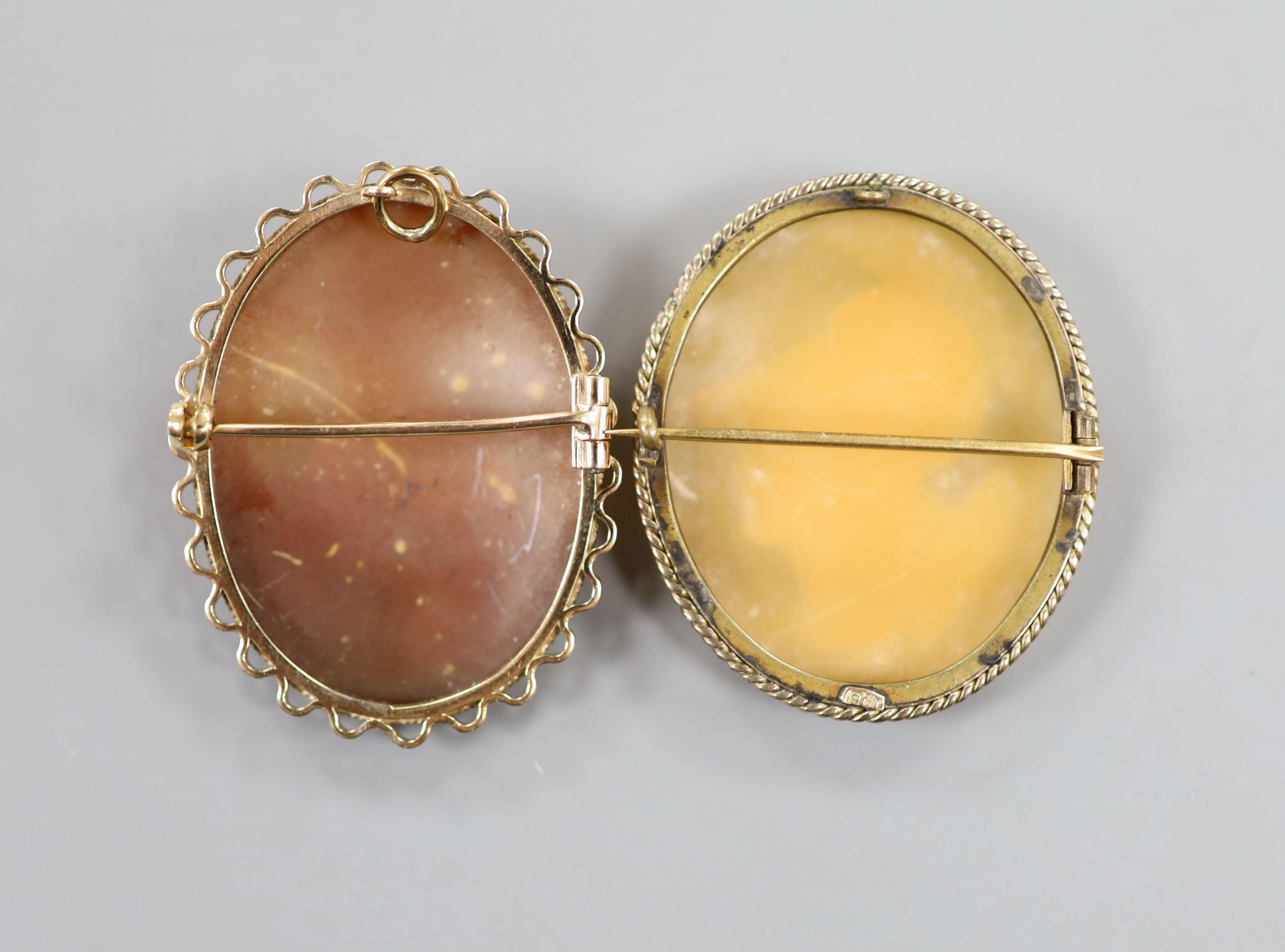 Two 9ct mounted oval cameo shell brooches, one with pendant mount, largest 44mm, gross weight 20 grams.